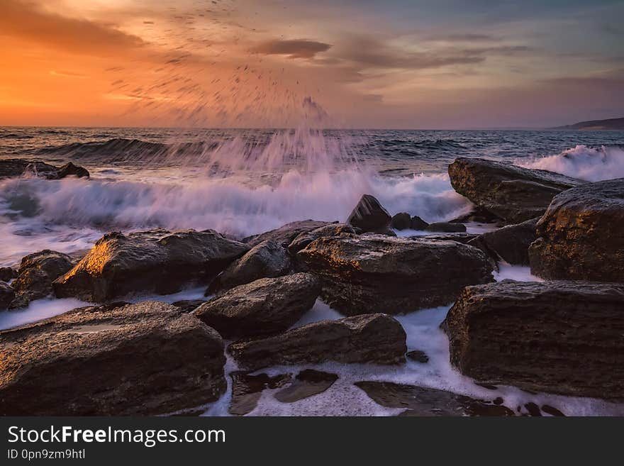 Amazing splash of seawater at morning on the shore of the Black Sea. Beautiful motion blur sea waves over the rocks