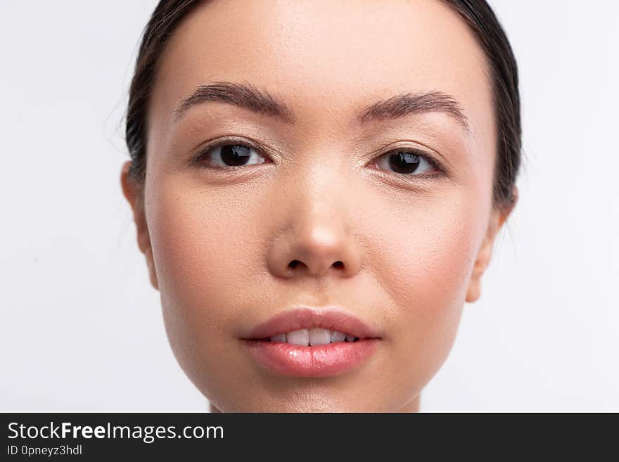 Dark-eyed woman with nice appearance feeling confident