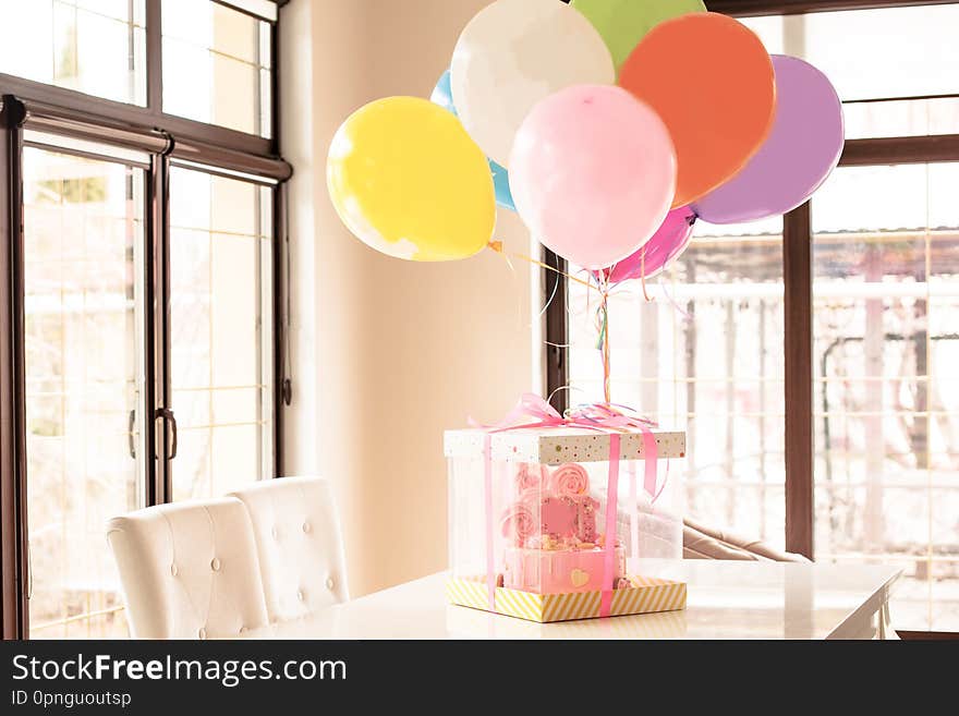 pink cake at the celebration of the first birthday of the girl, balloons  and congratulations, 1 year