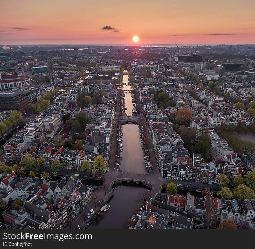 Aerial image of the keizersgracht in Amsterdam at sunrise. Looking towards the east, creating a line with the canal and rising sun. Aerial image of the keizersgracht in Amsterdam at sunrise. Looking towards the east, creating a line with the canal and rising sun