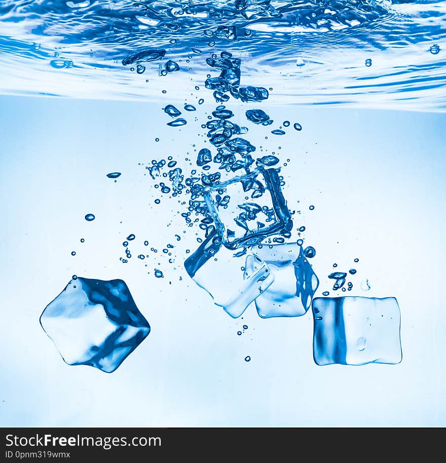 Ice cubes falling into the water sinking to the bottom. Abstract background. Ice cubes falling into the water sinking to the bottom. Abstract background