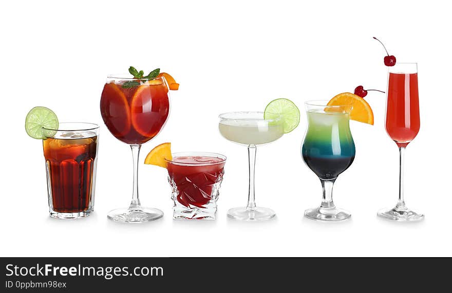 Glasses of traditional alcoholic cocktails on white background