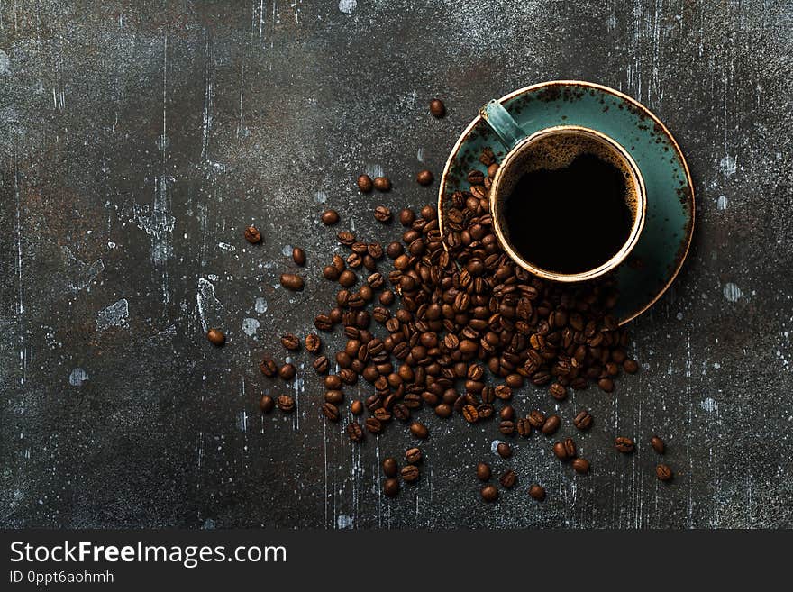 Coffee cup and coffee beans on vintage background, copy space