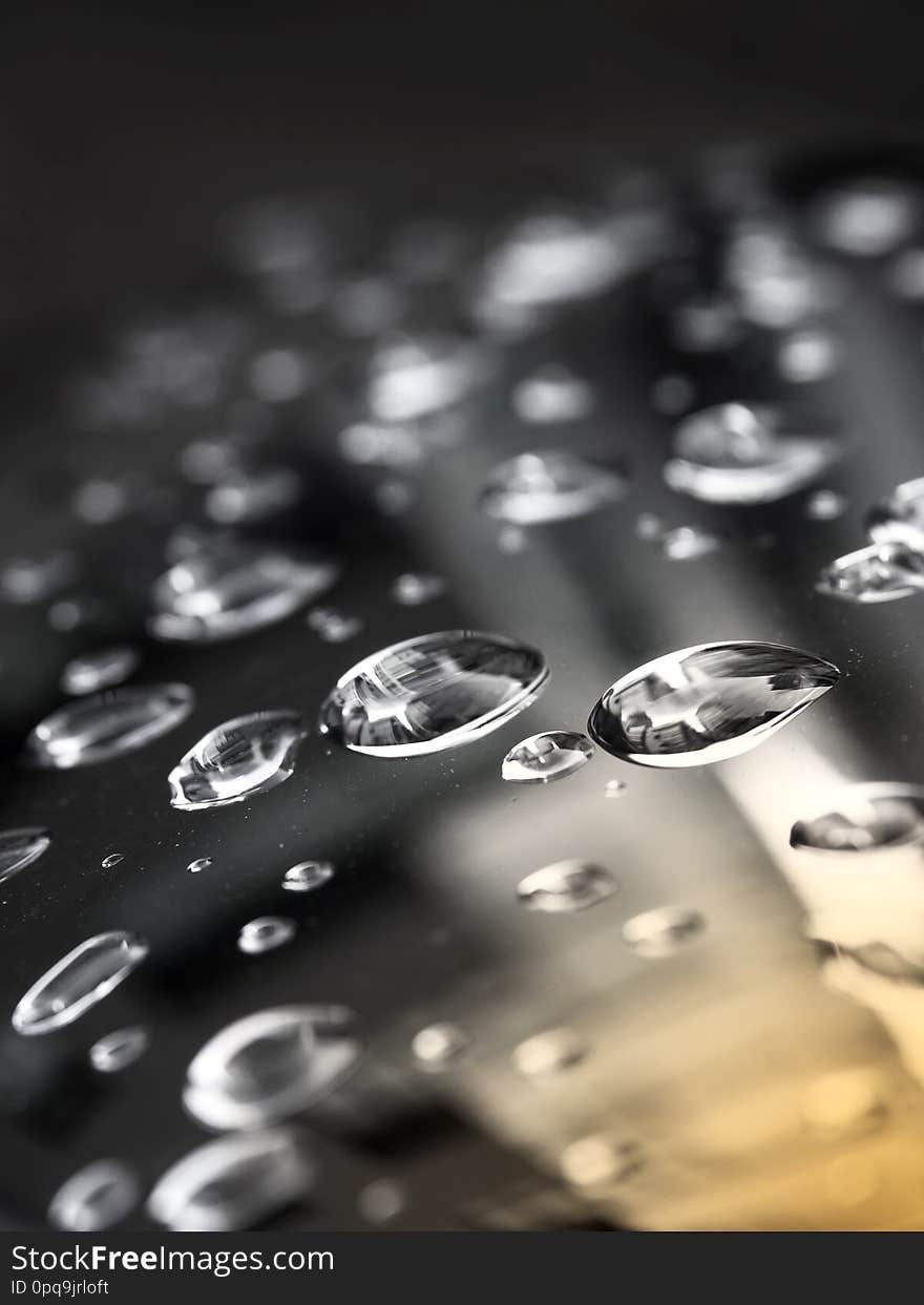 Close up rain drops on the black hood.