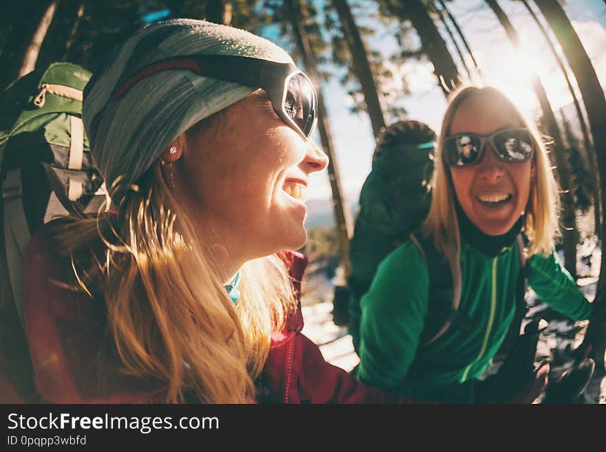 Two smiling women in a winter hike