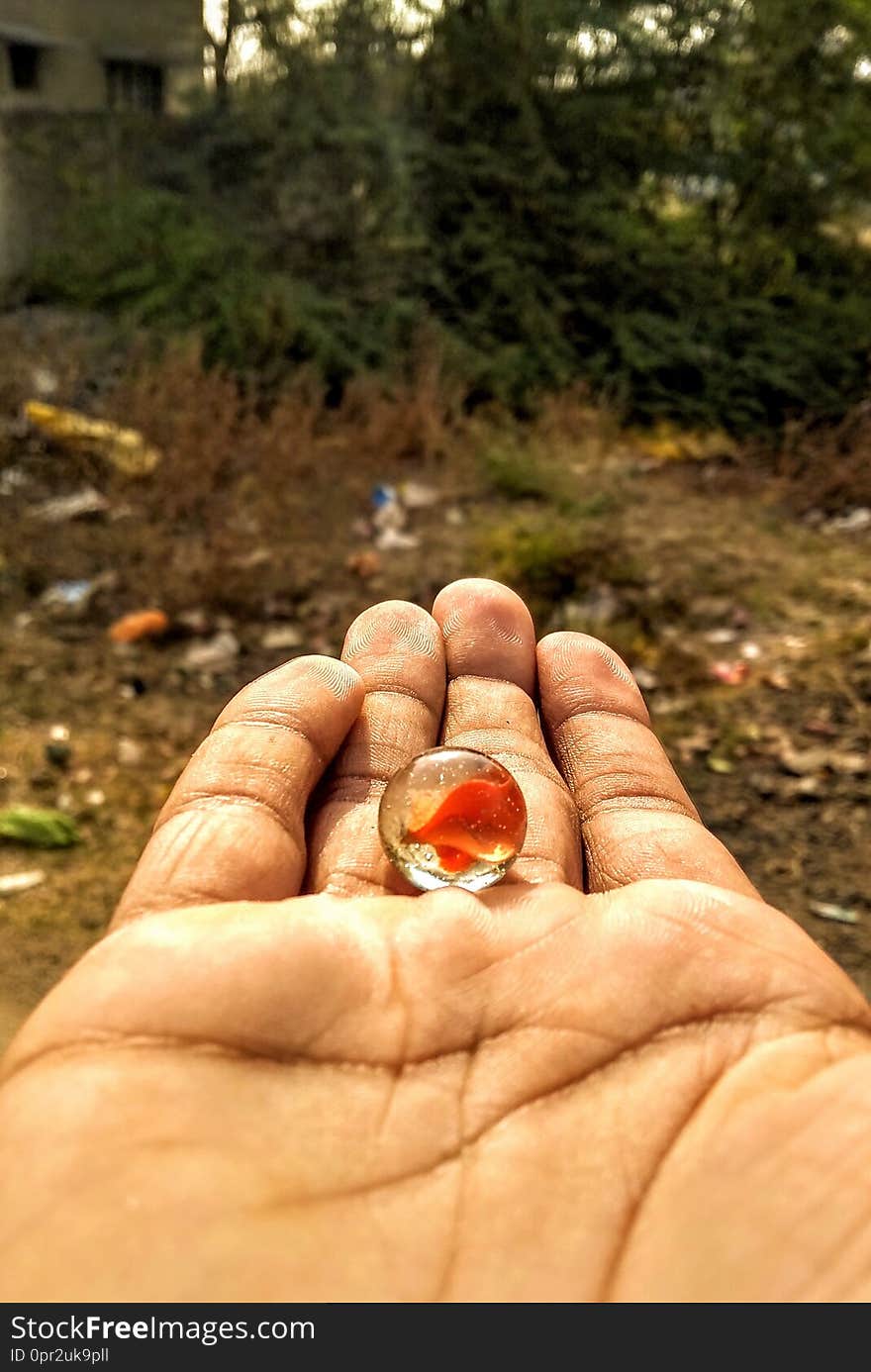 the playing indian marble ball called as kancha. playing in summer day when holidays. the playing indian marble ball called as kancha. playing in summer day when holidays.