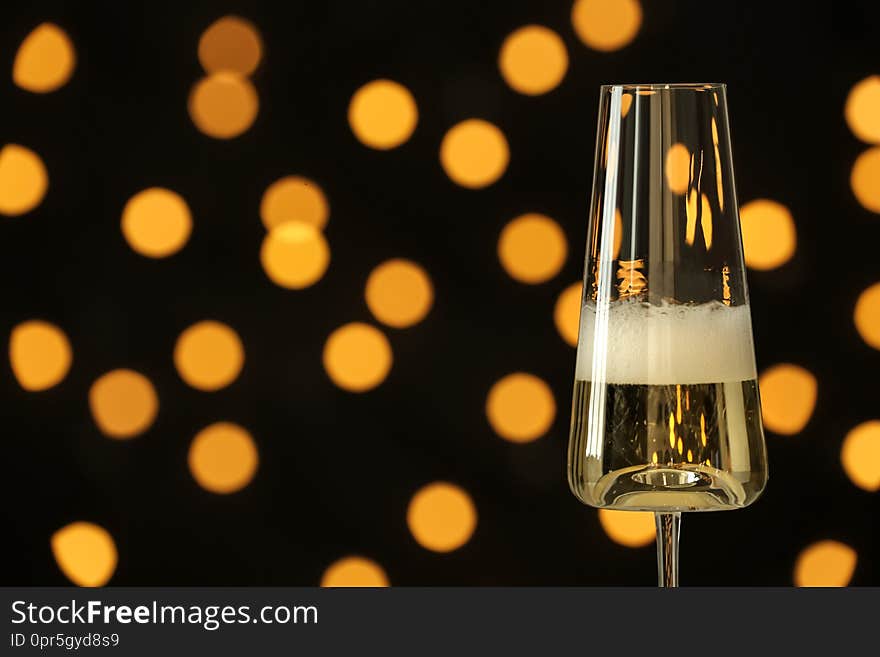 Glass of champagne against blurred lights