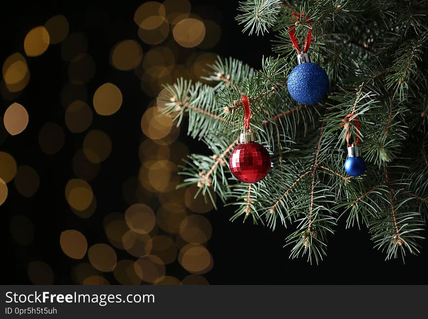 Beautifully decorated Christmas tree against blurred lights, space for text