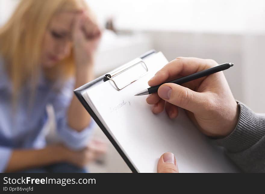 Pen in hands of smart professional male psychologist