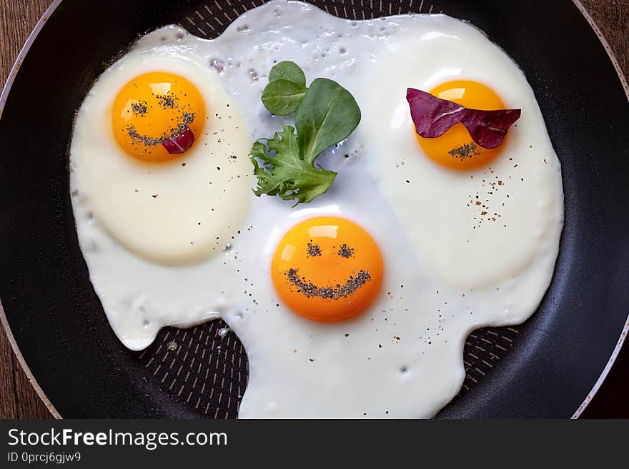 Breakfast of three fried eggs like emoticons