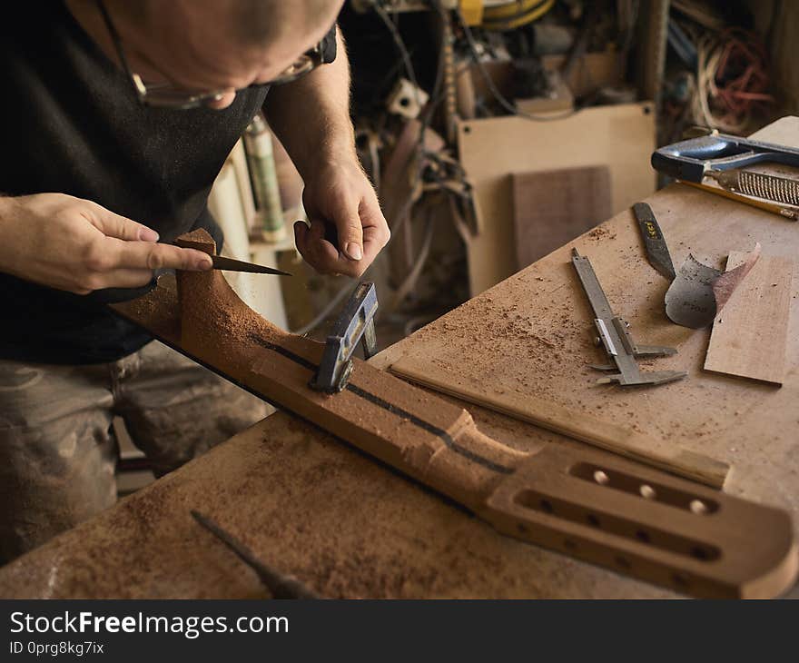 The guitar master makes guitar neck.