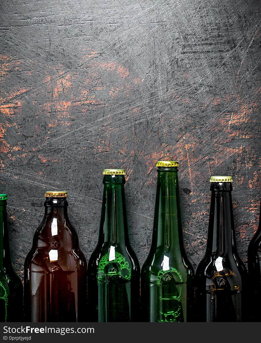 Closed beer bottles. On dark rustic background