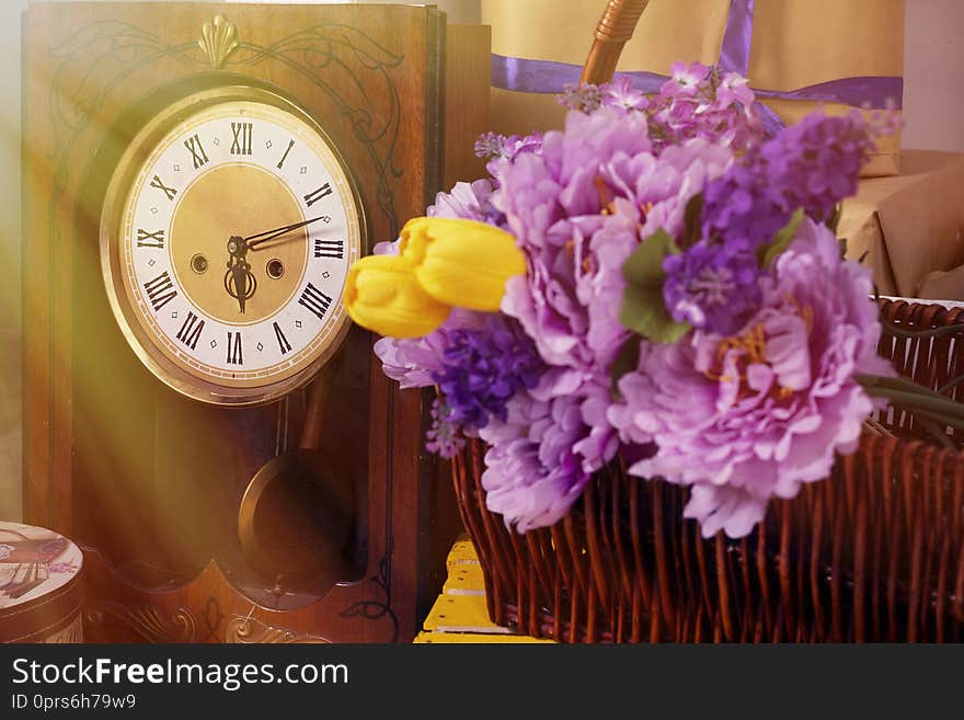 Spring photo with retro clock flowers in a basket a box of gifts tulips. Spring photo with retro clock flowers in a basket a box of gifts tulips