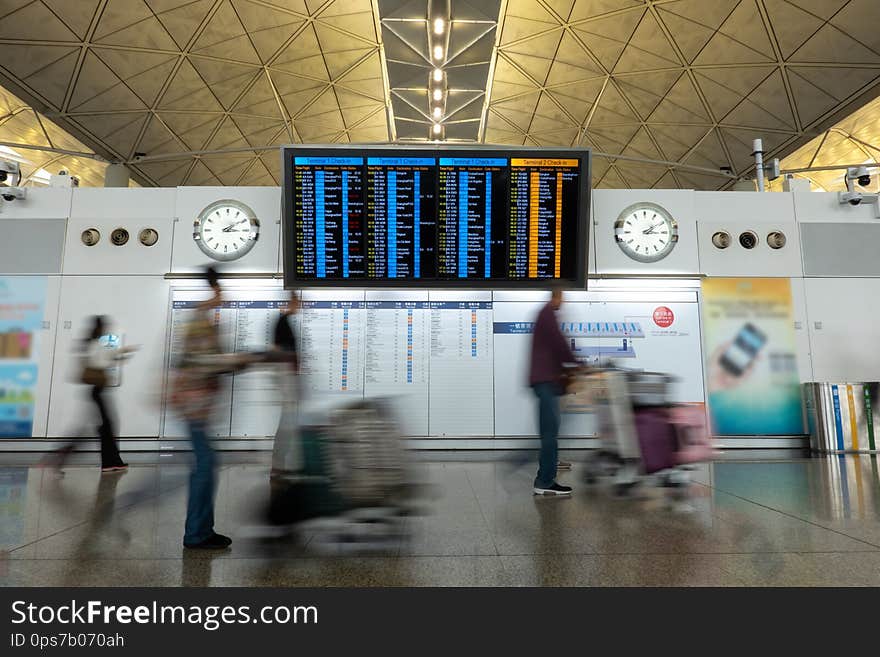 Passengers and Tourists checking schedule flying inside of hong kong Airport