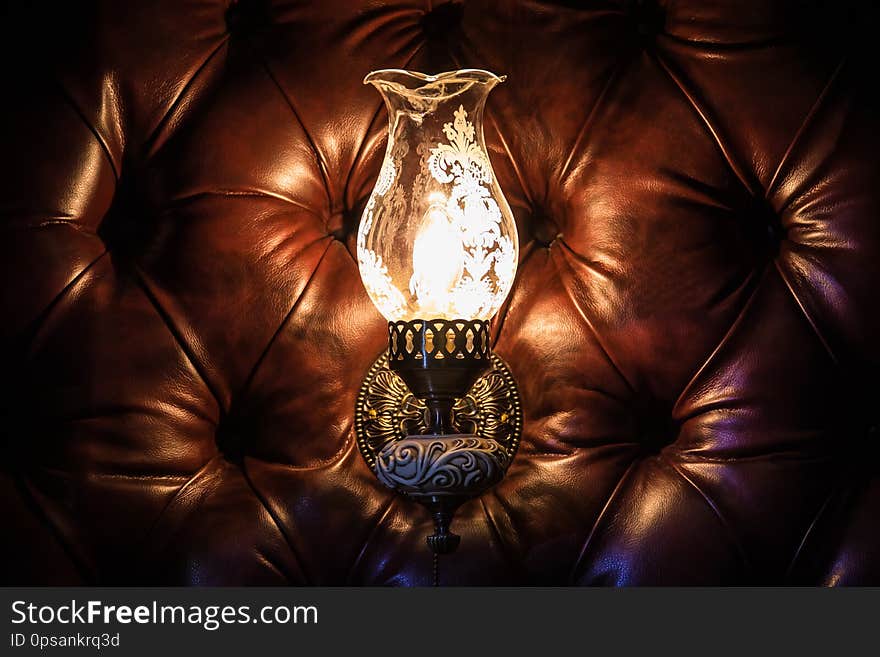 Antique lamp on the wall of leather.