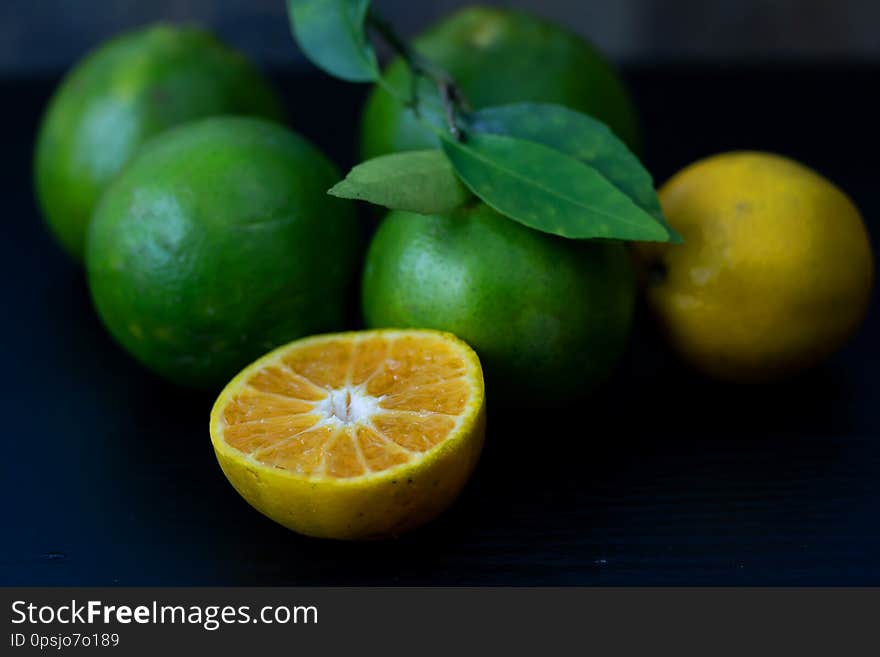 Fresh orange from the garden Cut half On the black wood table