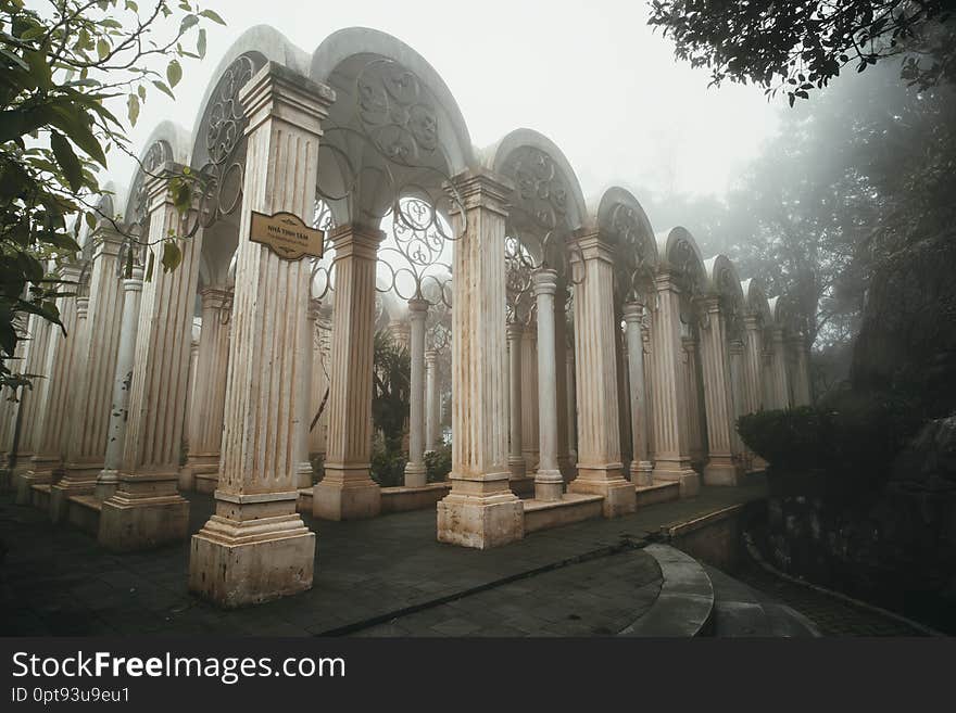 Place for meditation in the forest. An old architectural structure in the Park in front of the colonial castle on mount Bana hill