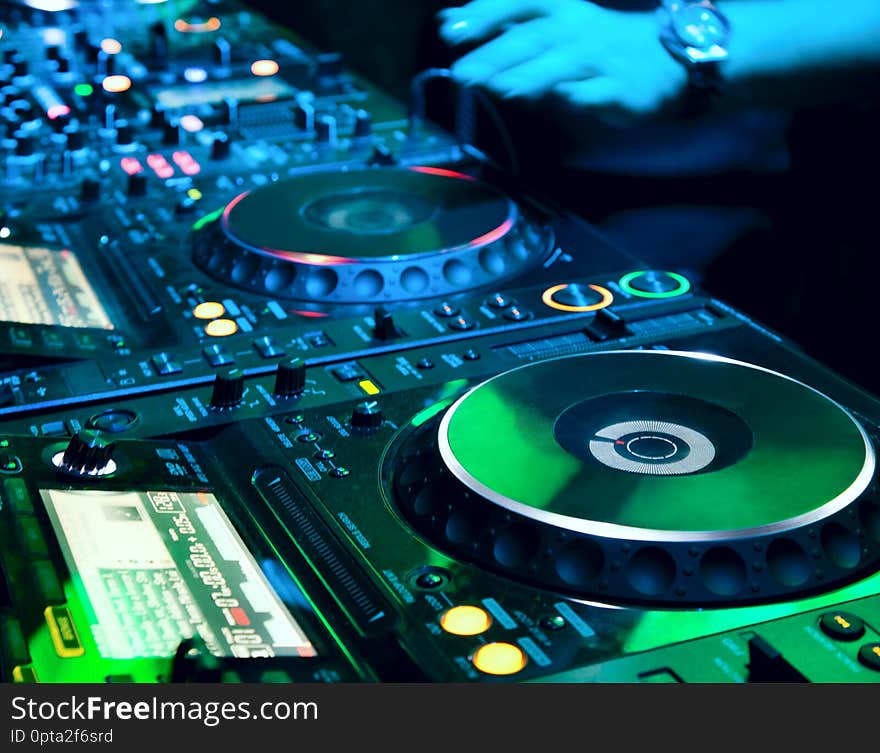 Dj playing the track in the nightclub at a party. Dj playing the track in the nightclub at a party