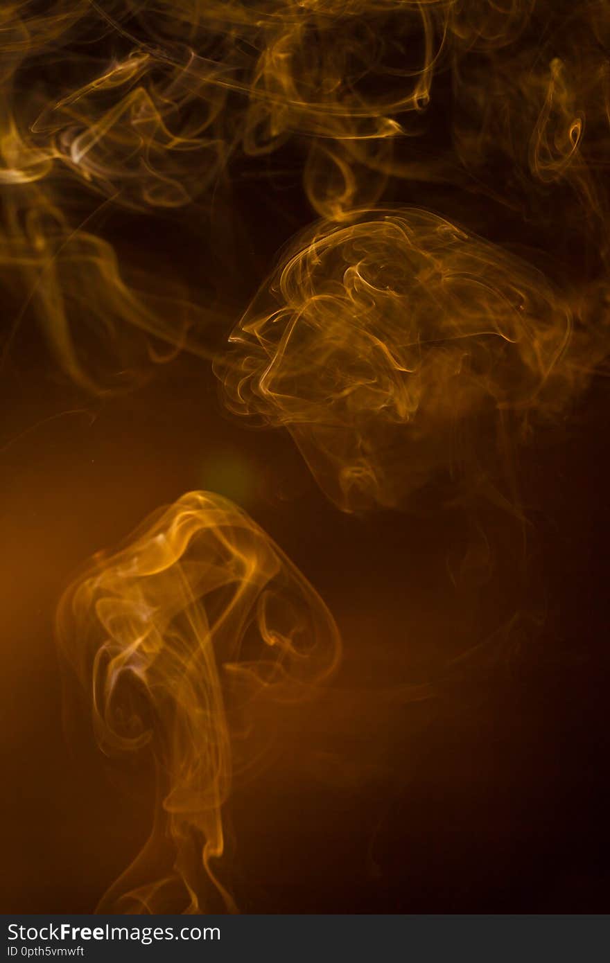 Gold smoke on black background.