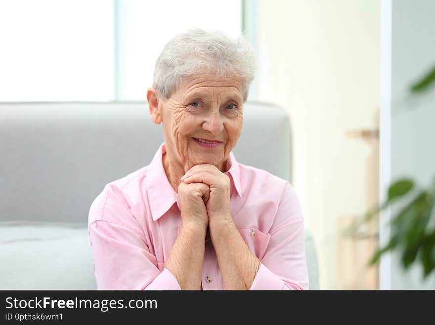 Portrait of beautiful grandmother in living room