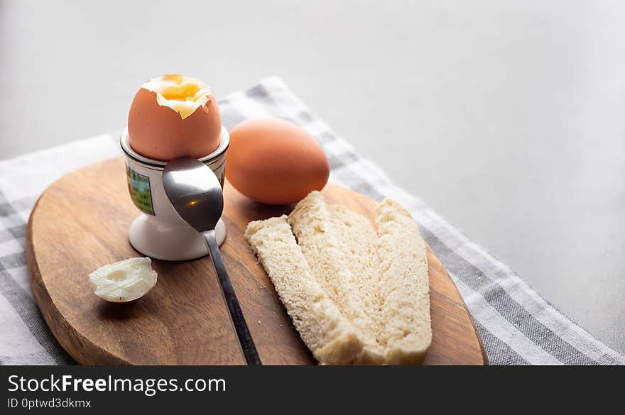 Breakfast boiled eggs with white bread on a table. Breakfast boiled eggs with white bread on a table