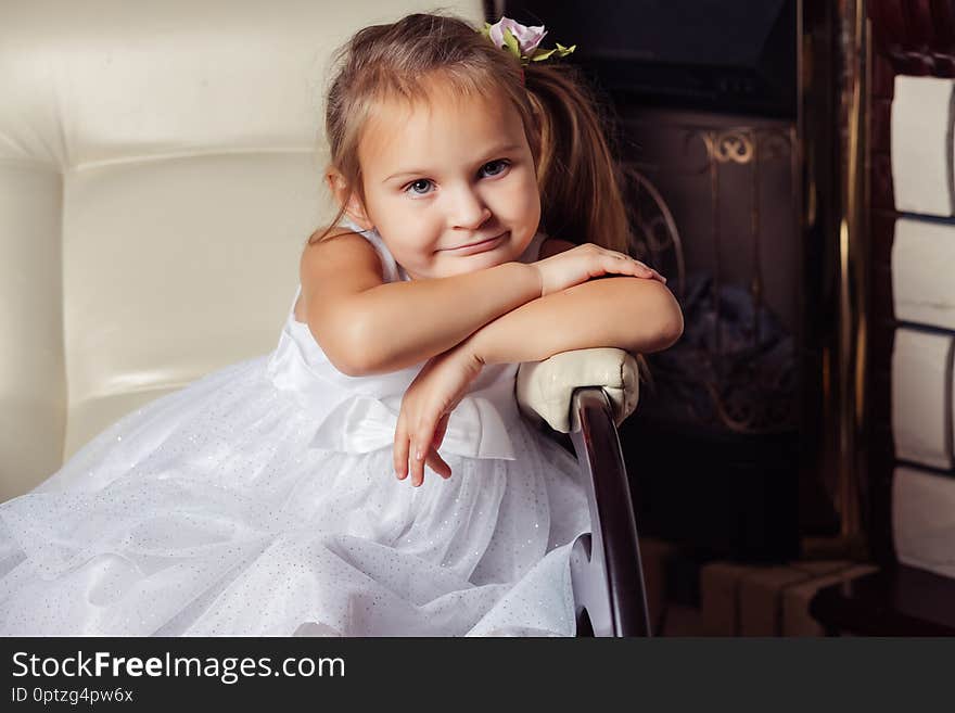 Little Girl Sitting On A Chair