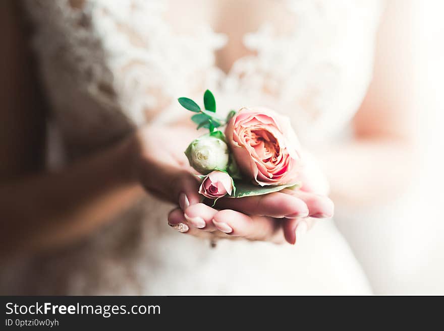 Bride holding big and beautiful wedding bouquet with flowers.