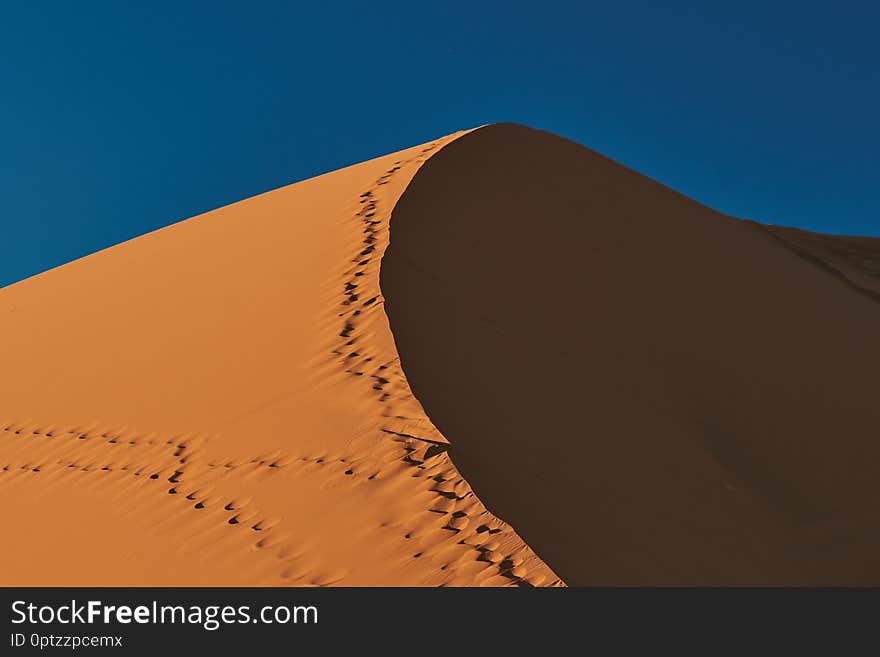 Large dune under a blue sky