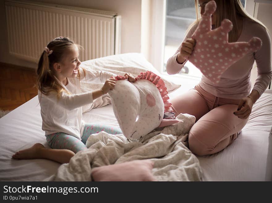 Go to the pillow fight. Mother daughter in bed