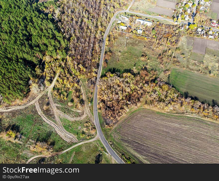 Aerial drone view of rural horse farm or ranch. Village or countryside with horse stables and barns