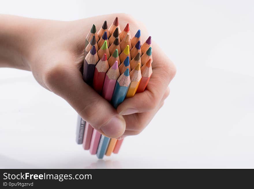 Hand holdin color pencils on a white background. Hand holdin color pencils on a white background