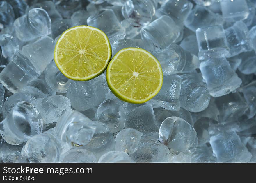 Nbackground banner halves of lime fruit citrus on cold ice