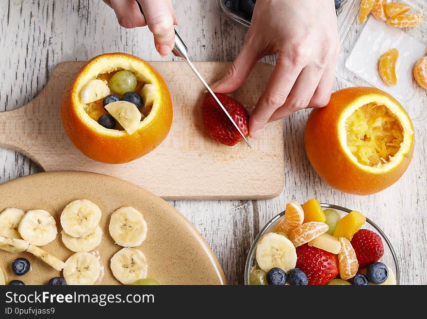 Orange filled with fruit salad. Healthy fruits