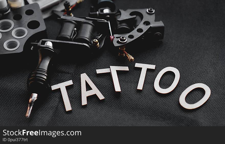 Tattoo Accessories With Inscription Tattoo Of Wooden Letters - Black Background