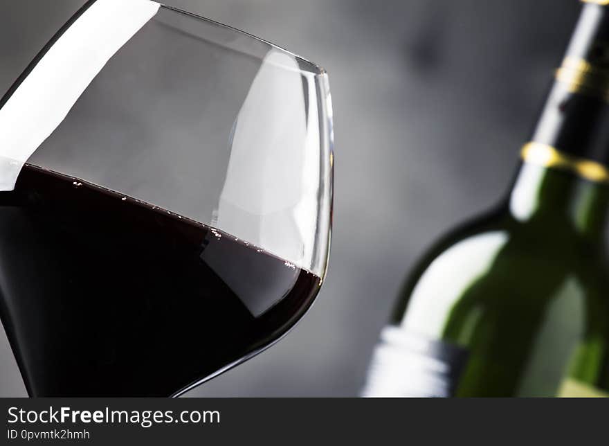 Red wine in wine glass, autumn still life with red and yellow leaves,  wine tasting, copy space, selective focus