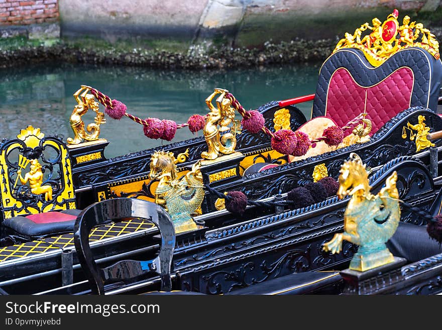 Close up of the interior of traditional venetian boat. It is rich, elegant and finely decorated with fine damask fabric. Venice, italy. Close up of the interior of traditional venetian boat. It is rich, elegant and finely decorated with fine damask fabric. Venice, italy