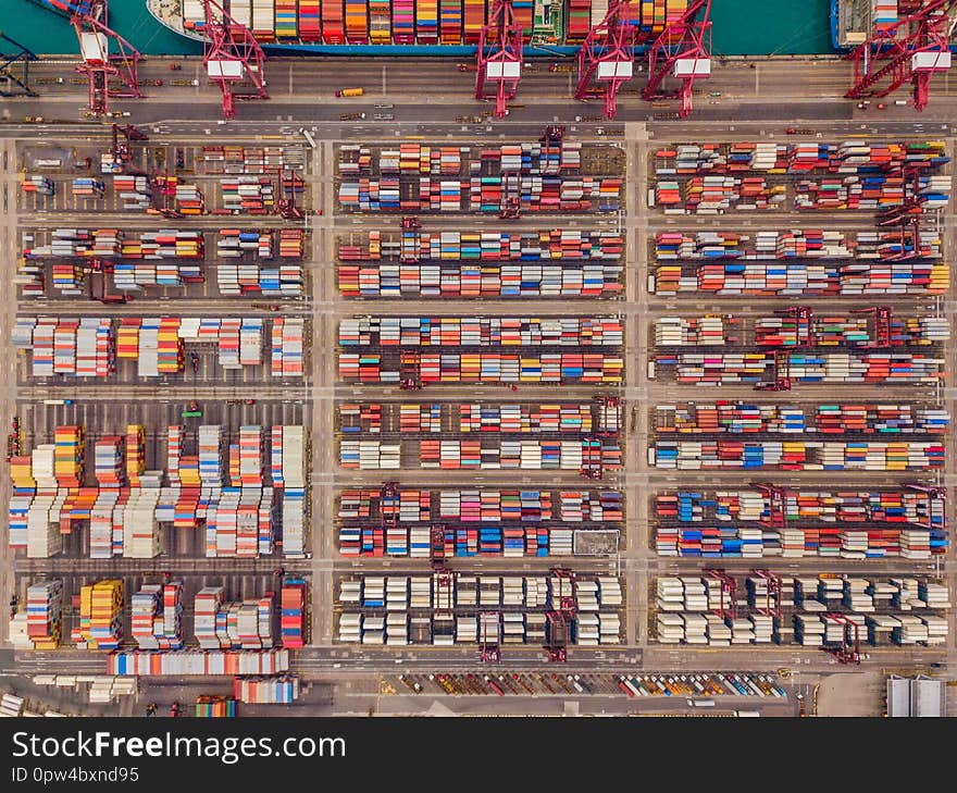 Aerial top view of container cargo ship in the export and import business and logistics international goods in urban city. Shipping to the harbor by crane in Victoria Harbour, Hong Kong