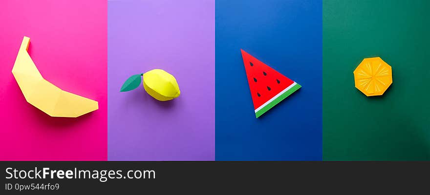 Set of fruit made of paper. Colorful background. Tropics. Flat lay. Banana, lemon, watermelon and orange