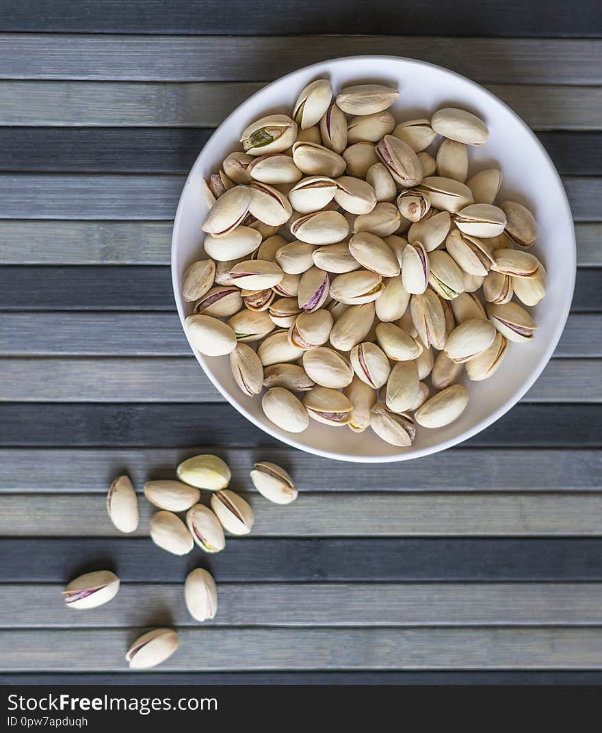 Healthy food  for background image close up pistachios nuts. Texture on top view Nuts pistachio on the cup plate.