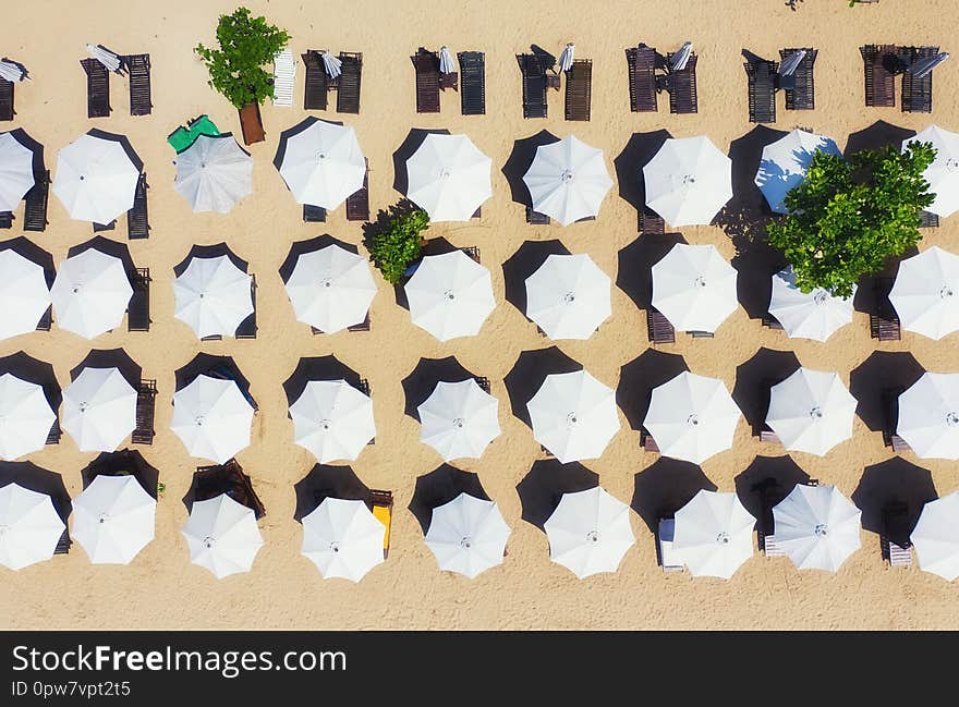 Umbrellas as a background from top view. Beach and sand background from top view. Summer seascape from air. Bali island, Indonesia