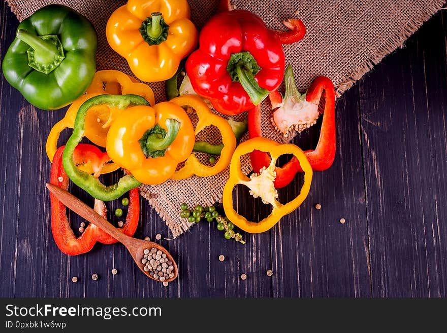 Three Sweet Peppers On A Wooden Background, Cooking Vegetable Salad