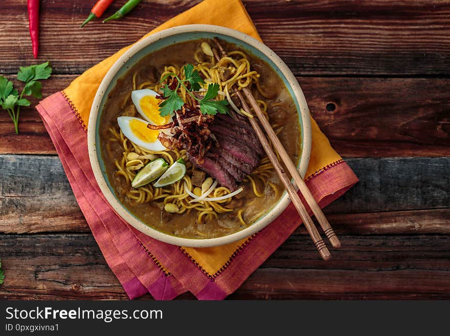 Malaysia Spicy Noodle Mee Rebus With Beef Egg and fried onion, copy space