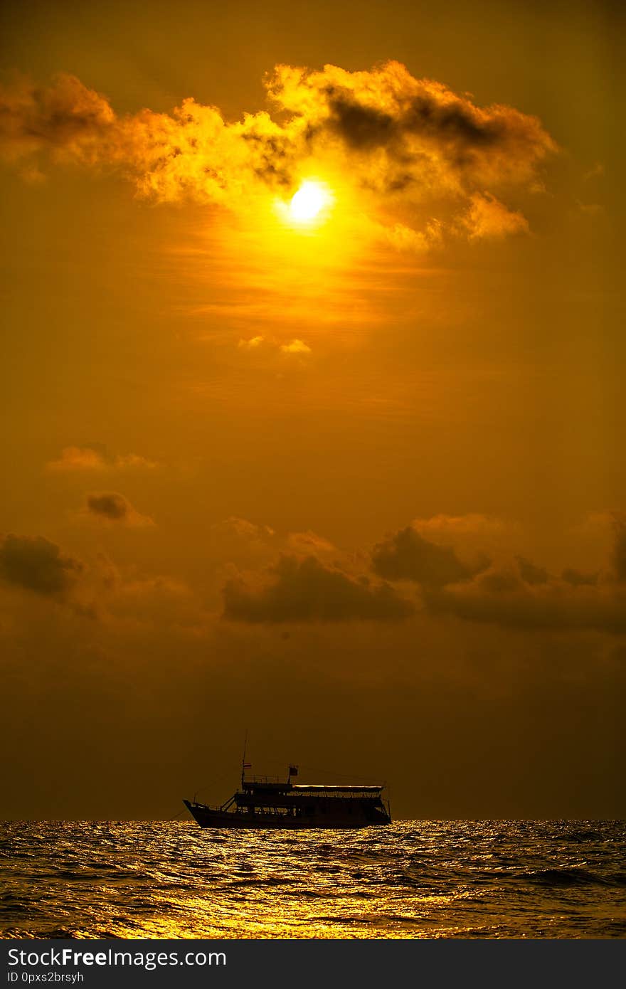 Boat on texture of tropical sea water and wave in golden light of sunset. Boat on texture of tropical sea water and wave in golden light of sunset