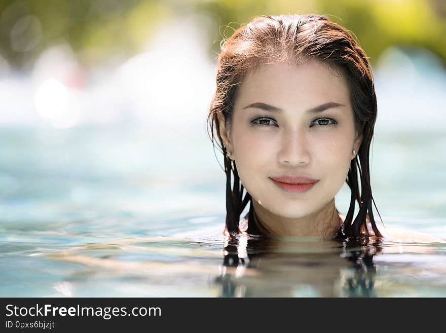 Face of  middle aged woman in clear water and looking to camera with copyspace on left. Face of  middle aged woman in clear water and looking to camera with copyspace on left