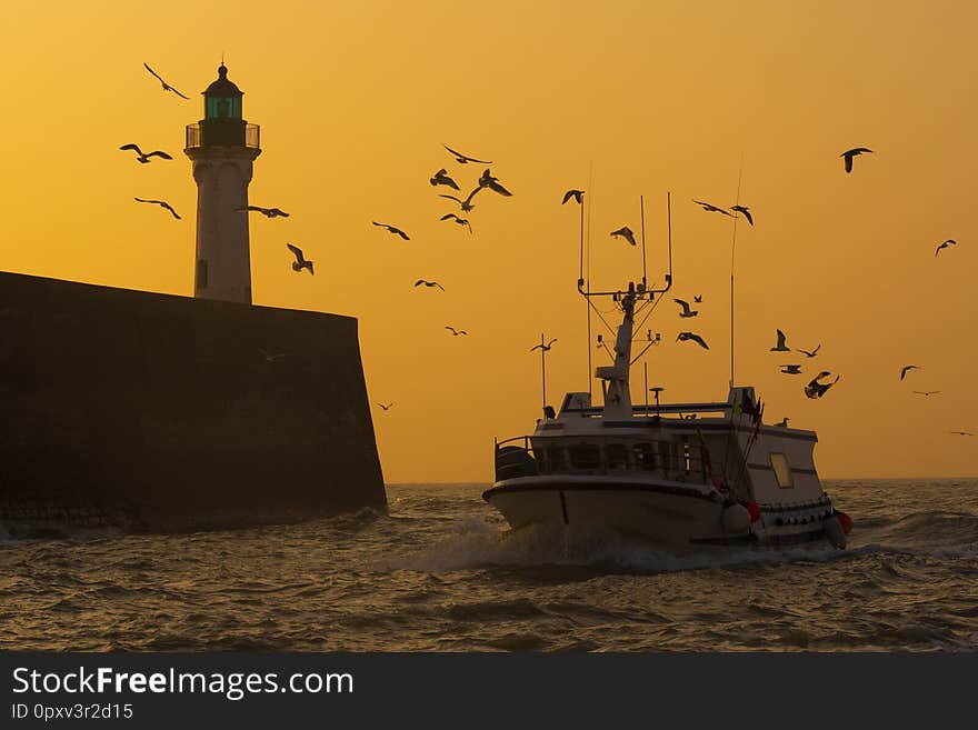 Cliff and Lighthouse at the entrance to the port of Saint Valery en Caux, sunset