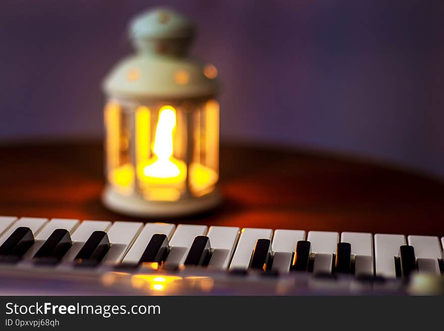 Keys  piano, lit by the light from the lantern in the evening. Evening concert_