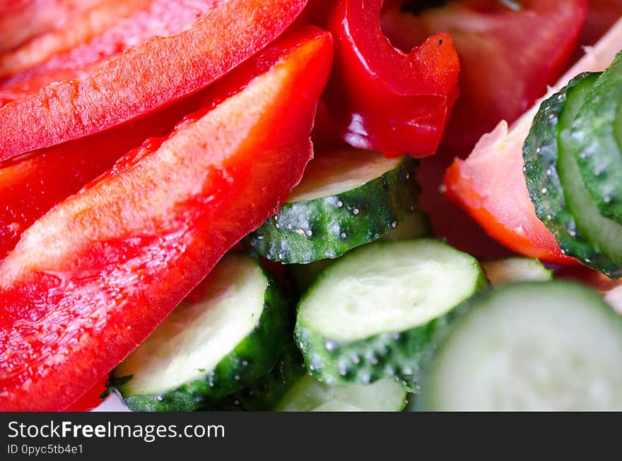 Fresh red pepper and green cucumber closeup