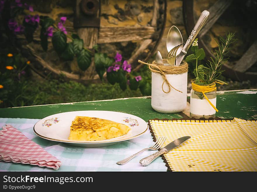 Spanish potato omelette on an old plate, picnic in a village. Spanish potato omelette on an old plate, picnic in a village