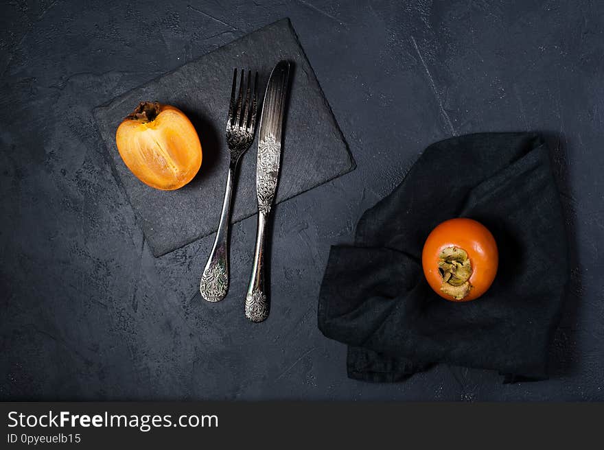 Healthy Dessert - Persimmon On A Black Background.