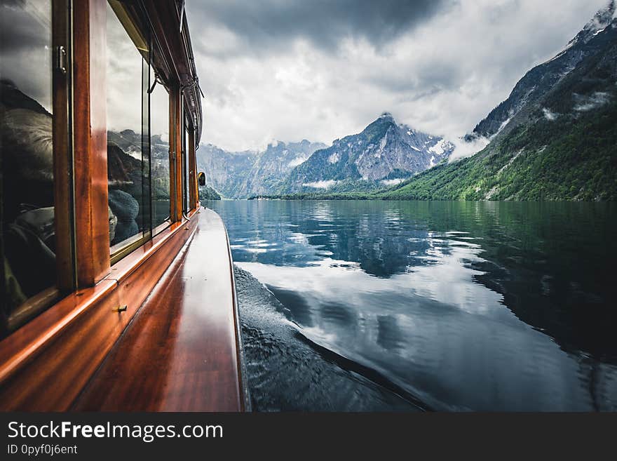 Traditional boat on famous Lake Konigssee on a beautiful modoy cloudy day in summer, Berchtesgadener Land, Bavaria, Germany. Traditional boat on famous Lake Konigssee on a beautiful modoy cloudy day in summer, Berchtesgadener Land, Bavaria, Germany